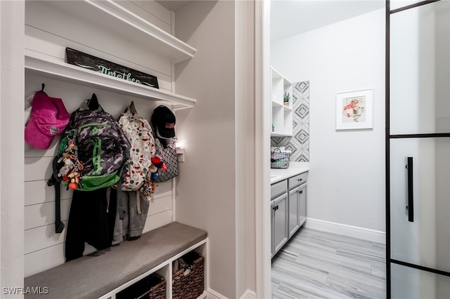 mudroom with light wood-style floors and baseboards