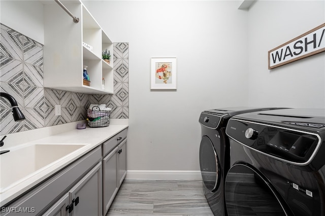 laundry area featuring washer and clothes dryer and cabinet space
