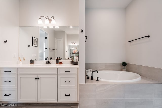 bathroom with vanity and a bath