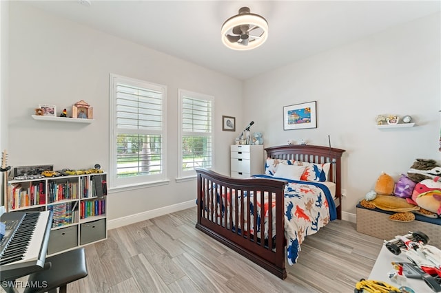 bedroom featuring wood finished floors and baseboards
