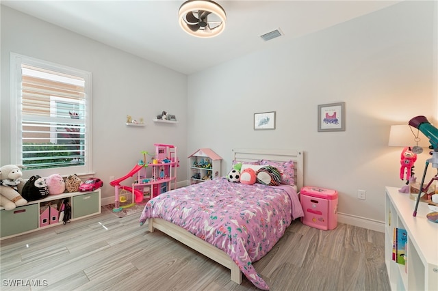 bedroom featuring wood finished floors and baseboards