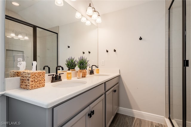 full bathroom with double vanity and tiled shower