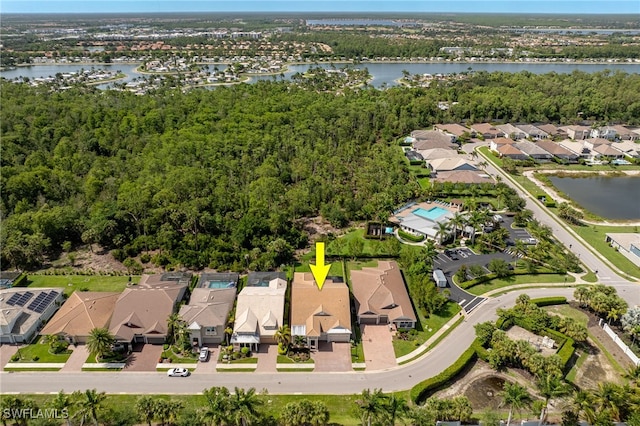 aerial view of property and surrounding area with nearby suburban area and a nearby body of water