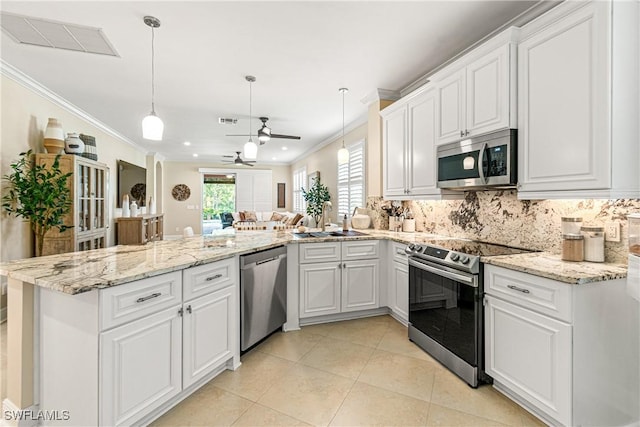 10622 Camarelle Cir, Fort Myers, FL 33913 - kitchen featuring stainless steel appliances, ornamental molding, a peninsula, a ceiling fan, and white cabinets