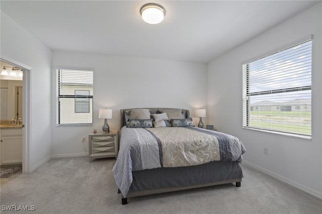 14688 Cantabria Dr, Fort Myers, FL 33905 - bedroom with multiple windows, light carpet, and ensuite bath