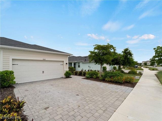 17857 Woodland Ct, Punta Gorda, FL 33982 - view of front of property with decorative driveway and a garage