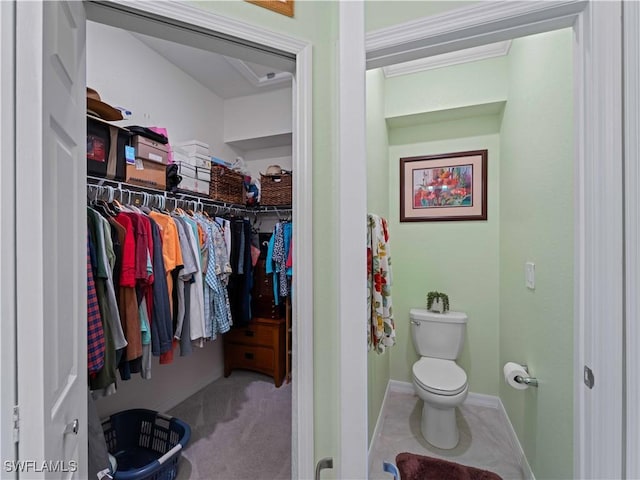 17857 Woodland Ct, Punta Gorda, FL 33982 - bathroom featuring a walk in closet and ornamental molding