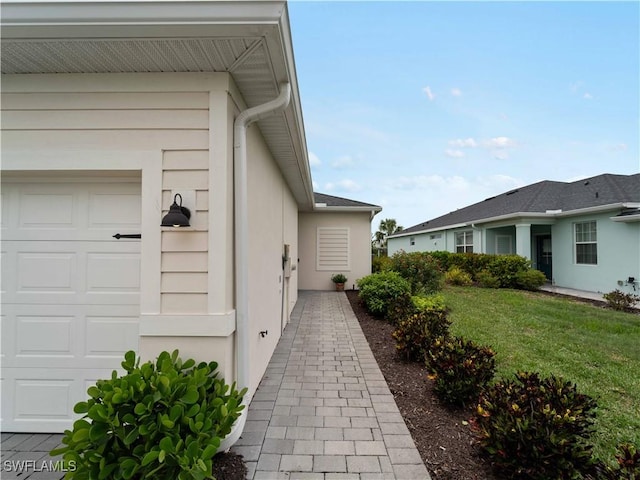17857 Woodland Ct, Punta Gorda, FL 33982 - view of side of home with stucco siding and a yard