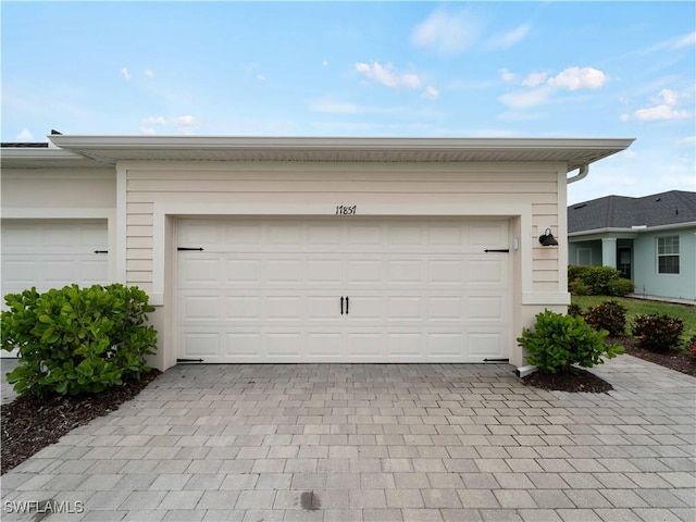 17857 Woodland Ct, Punta Gorda, FL 33982 - garage featuring decorative driveway