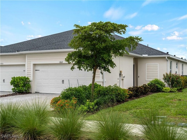 17857 Woodland Ct, Punta Gorda, FL 33982 - view of side of property featuring stucco siding, a garage, a shingled roof, and concrete driveway