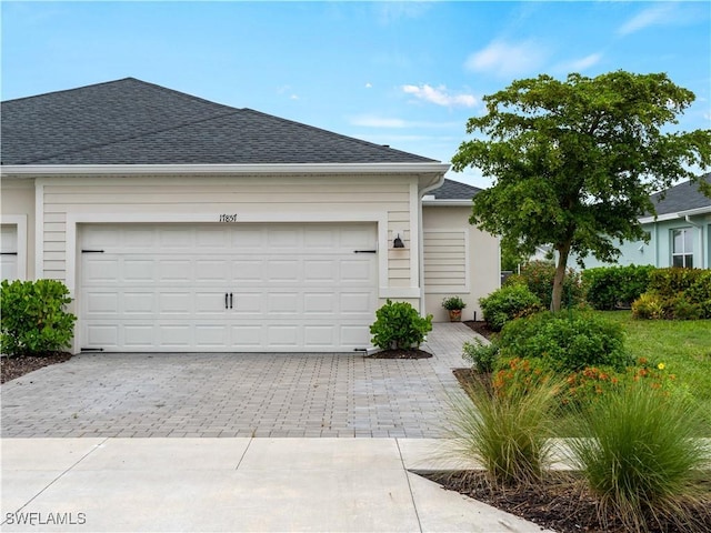 17857 Woodland Ct, Punta Gorda, FL 33982 - ranch-style home with decorative driveway, roof with shingles, and a garage