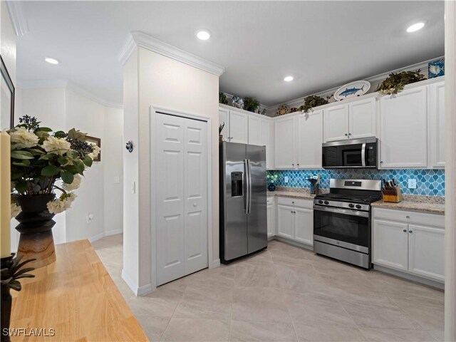17857 Woodland Ct, Punta Gorda, FL 33982 - kitchen featuring appliances with stainless steel finishes, backsplash, white cabinetry, ornamental molding, and recessed lighting