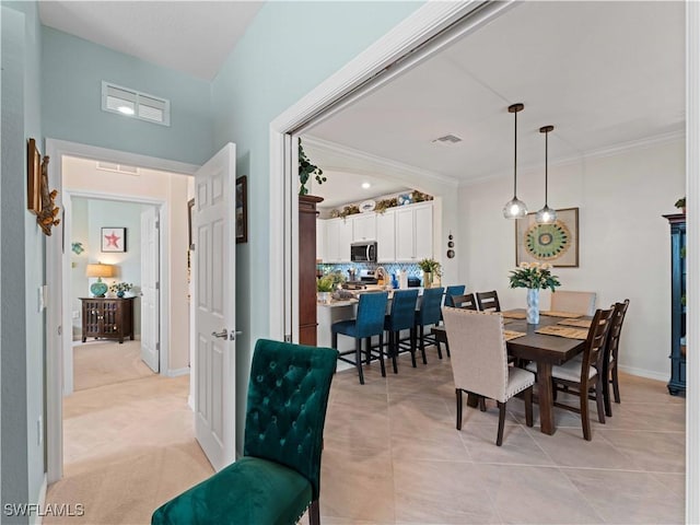 17857 Woodland Ct, Punta Gorda, FL 33982 - dining space with ornamental molding and light tile patterned floors