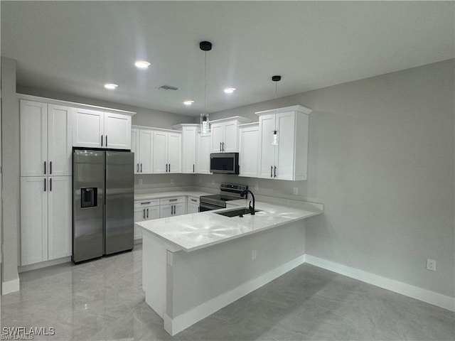 3003 18th St W, Lehigh Acres, FL 33976 - kitchen featuring appliances with stainless steel finishes, baseboards, light countertops, recessed lighting, and a peninsula