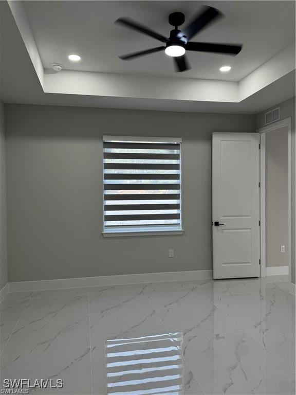 3003 18th St W, Lehigh Acres, FL 33976 - empty room with baseboards, a raised ceiling, and recessed lighting