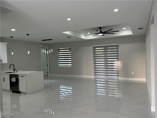 3003 18th St W, Lehigh Acres, FL 33976 - unfurnished living room featuring baseboards, a ceiling fan, a sink, a tray ceiling, and recessed lighting