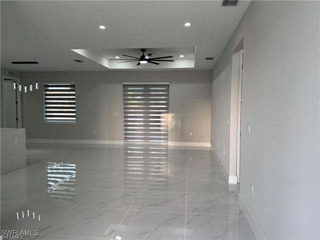 3003 18th St W, Lehigh Acres, FL 33976 - empty room with a raised ceiling, a ceiling fan, baseboards, light marble finish flooring, and recessed lighting