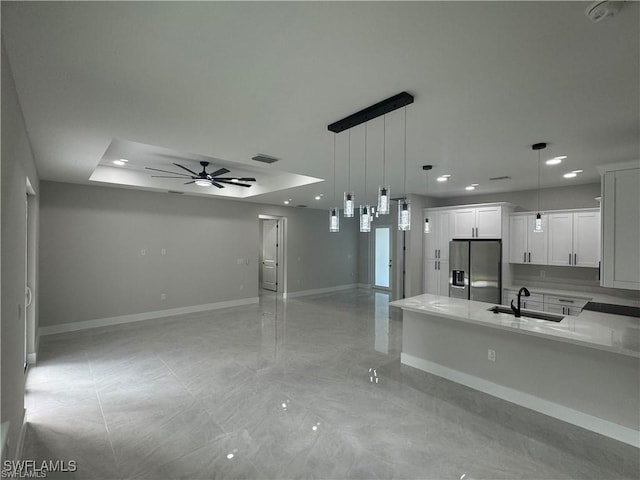 3003 18th St W, Lehigh Acres, FL 33976 - kitchen featuring stainless steel refrigerator with ice dispenser, a sink, white cabinets, baseboards, and ceiling fan