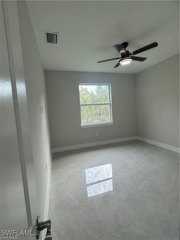 3003 18th St W, Lehigh Acres, FL 33976 - empty room featuring ceiling fan and baseboards