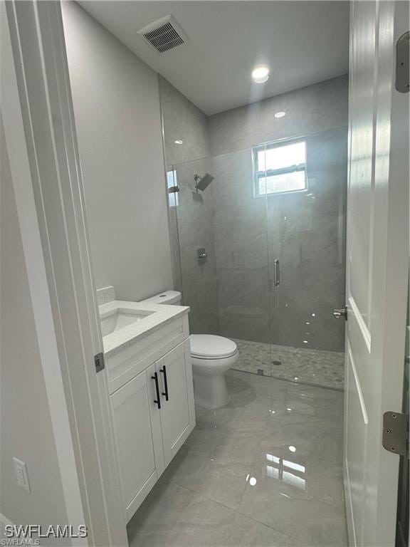 3003 18th St W, Lehigh Acres, FL 33976 - bathroom with vanity, toilet, marble finish floors, a shower stall, and recessed lighting