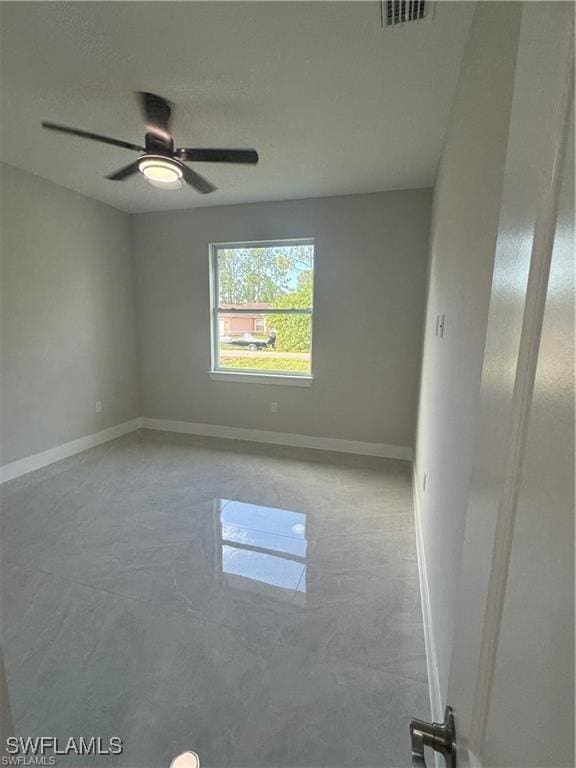 3003 18th St W, Lehigh Acres, FL 33976 - unfurnished room featuring baseboards and a ceiling fan
