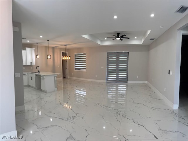 3003 18th St W, Lehigh Acres, FL 33976 - unfurnished living room with ceiling fan, light marble finish floors, recessed lighting, and a tray ceiling