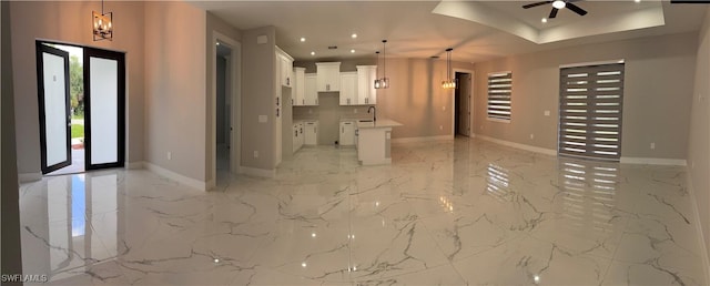 3003 18th St W, Lehigh Acres, FL 33976 - unfurnished living room featuring light marble finish floors, a ceiling fan, recessed lighting, and a chandelier