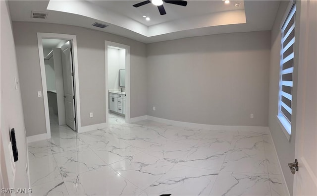 3003 18th St W, Lehigh Acres, FL 33976 - unfurnished bedroom with a walk in closet, a tray ceiling, light marble finish floors, recessed lighting, and multiple windows