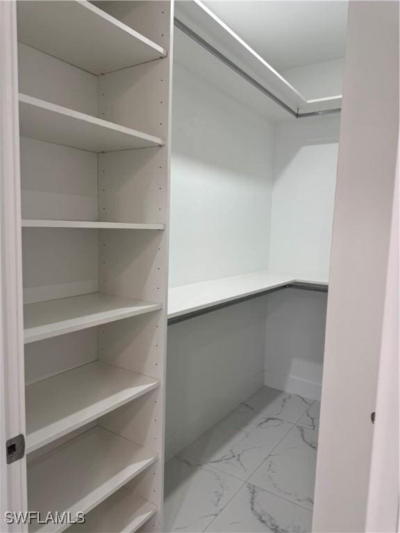 3003 18th St W, Lehigh Acres, FL 33976 - walk in closet with marble look tile flooring