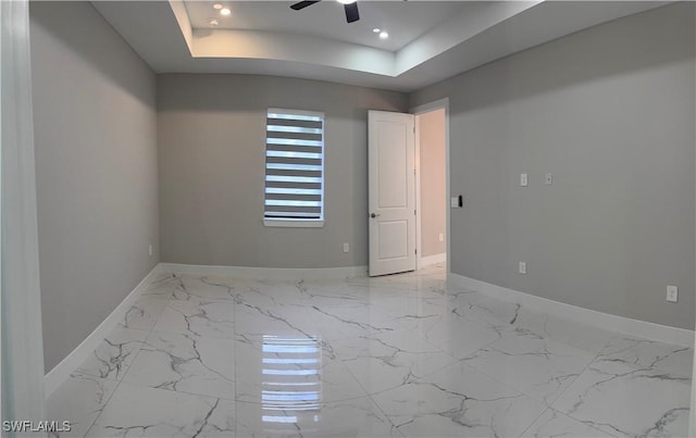 3003 18th St W, Lehigh Acres, FL 33976 - unfurnished room with marble finish flooring, a ceiling fan, recessed lighting, and a tray ceiling