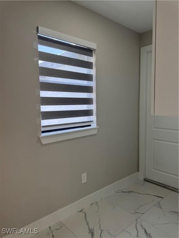3003 18th St W, Lehigh Acres, FL 33976 - spare room featuring plenty of natural light and light marble finish floors