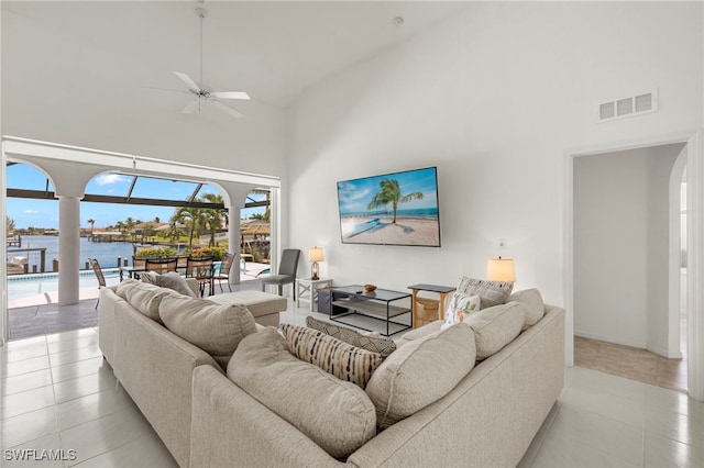 3925 Oasis Blvd, Cape Coral, FL 33914 - living room with high vaulted ceiling, ceiling fan, light tile patterned floors, and arched walkways