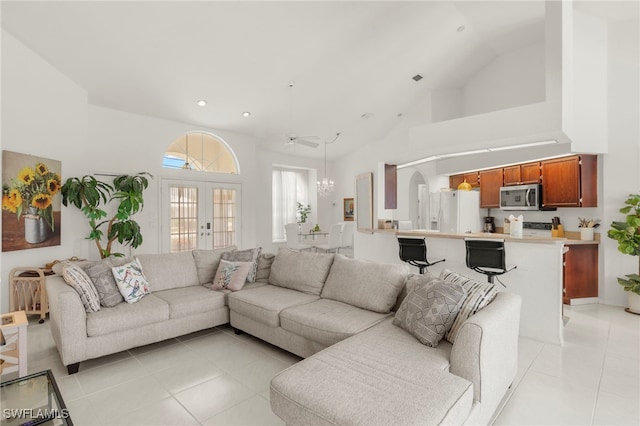 3925 Oasis Blvd, Cape Coral, FL 33914 - living room with light tile patterned floors, high vaulted ceiling, recessed lighting, french doors, and a chandelier