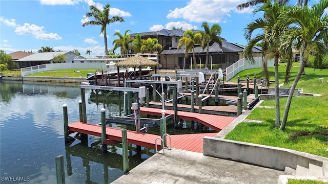 3925 Oasis Blvd, Cape Coral, FL 33914 - dock featuring boat lift, a water view, and a yard
