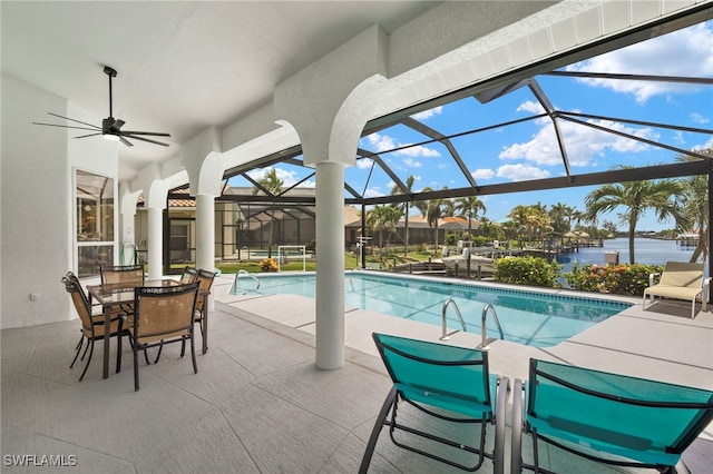 3925 Oasis Blvd, Cape Coral, FL 33914 - outdoor pool with a patio area, outdoor dining area, a water view, glass enclosure, and a ceiling fan