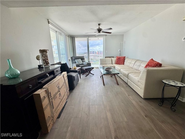 7390 Estero Blvd Unit 702, Fort Myers Beach, FL 33931 - living room featuring light wood finished floors, a ceiling fan, and floor to ceiling windows