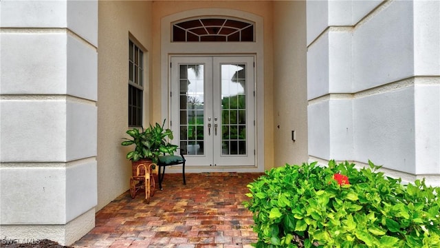 8871 Biella Ct, Estero, FL 33967 - view of exterior entry with french doors and stucco siding