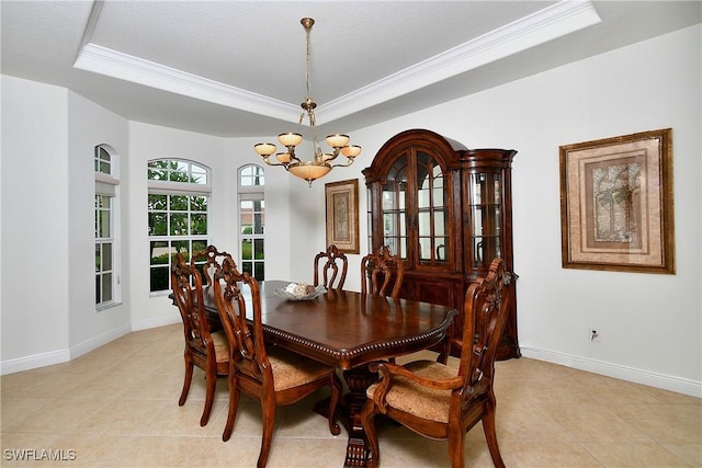 8871 Biella Ct, Estero, FL 33967 - dining space featuring a raised ceiling, a chandelier, crown molding, light tile patterned floors, and baseboards
