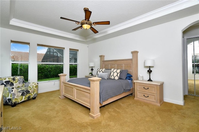 8871 Biella Ct, Estero, FL 33967 - bedroom featuring light carpet, a raised ceiling, ornamental molding, arched walkways, and baseboards