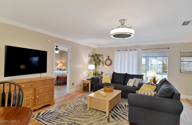 8780 Lueck Ln Unit 4, Fort Myers, FL 33919 - living area with light wood-style floors, ornamental molding, baseboards, and a ceiling fan