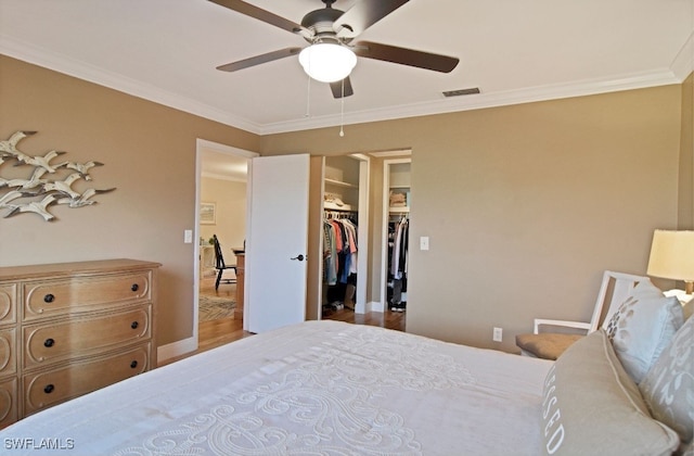 8780 Lueck Ln Unit 4, Fort Myers, FL 33919 - bedroom with crown molding, wood finished floors, a walk in closet, and ceiling fan
