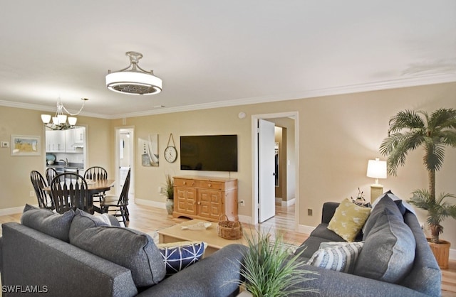 8780 Lueck Ln Unit 4, Fort Myers, FL 33919 - living area with a chandelier, ornamental molding, baseboards, and light wood-style floors