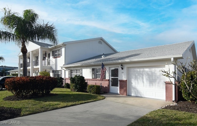 8780 Lueck Ln Unit 4, Fort Myers, FL 33919 - view of front facade featuring a garage, driveway, brick siding, and a front yard
