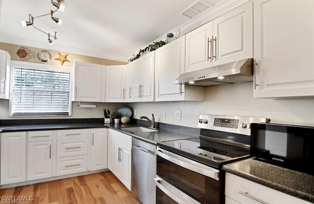 8780 Lueck Ln Unit 4, Fort Myers, FL 33919 - kitchen with appliances with stainless steel finishes, under cabinet range hood, a sink, white cabinetry, and dark countertops