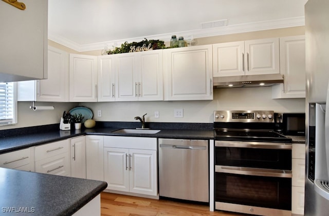 8780 Lueck Ln Unit 4, Fort Myers, FL 33919 - kitchen featuring stainless steel appliances, a sink, under cabinet range hood, white cabinetry, and ornamental molding