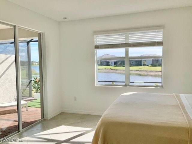 2011 Vermont Ln, Naples, FL 34120 - bedroom with access to exterior, a water view, light tile patterned floors, and baseboards