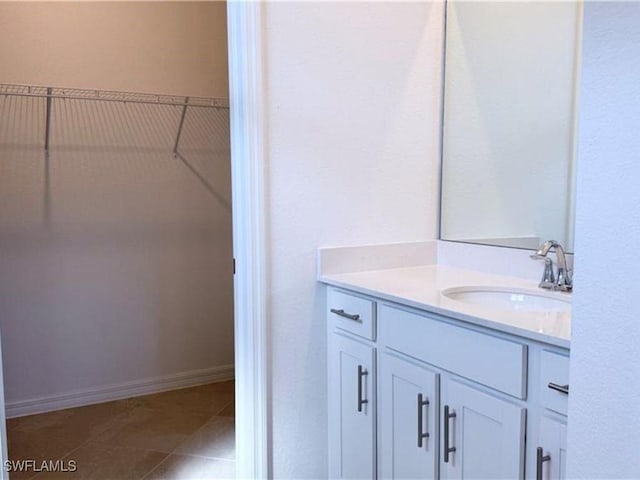 2011 Vermont Ln, Naples, FL 34120 - bathroom with vanity, a walk in closet, and tile patterned floors