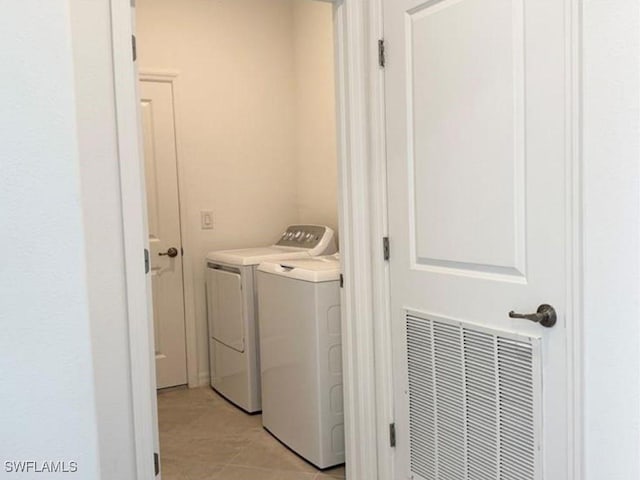 2011 Vermont Ln, Naples, FL 34120 - laundry room with washing machine and dryer and light tile patterned flooring