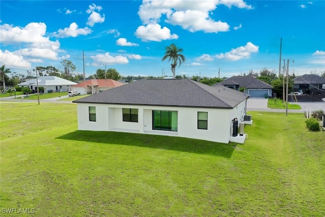 2008 NW 24th Pl, Cape Coral, FL 33993 - back of house featuring stucco siding, a lawn, and a residential view