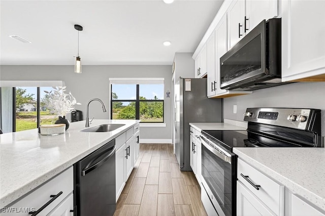 2008 NW 24th Pl, Cape Coral, FL 33993 - kitchen with dishwasher, stainless steel electric range, healthy amount of natural light, white cabinets, and recessed lighting